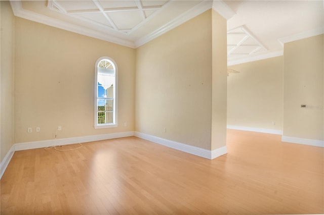 empty room with hardwood / wood-style flooring, ornamental molding, and coffered ceiling