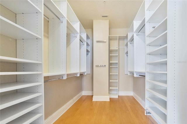 walk in closet featuring hardwood / wood-style flooring