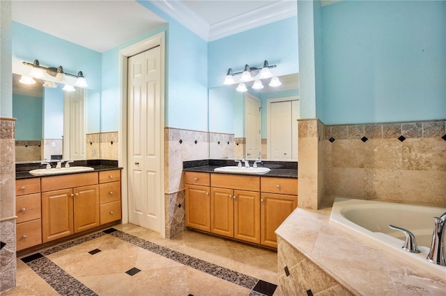 bathroom with a relaxing tiled tub, tile walls, vanity, and crown molding