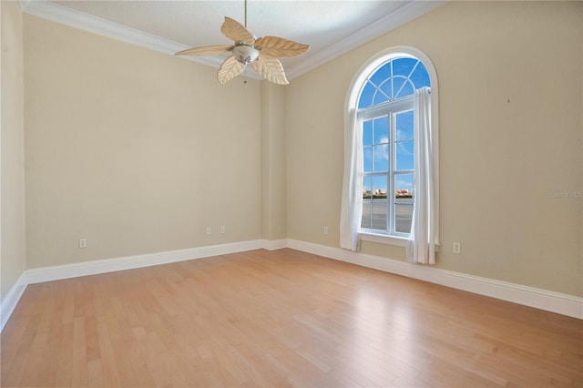 spare room featuring ceiling fan, light wood-type flooring, and ornamental molding