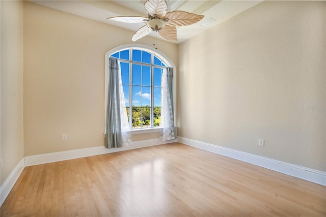 empty room with light wood-type flooring and ceiling fan