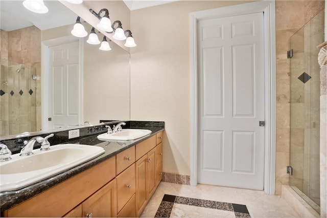 bathroom with a shower with shower door, tile patterned floors, and vanity