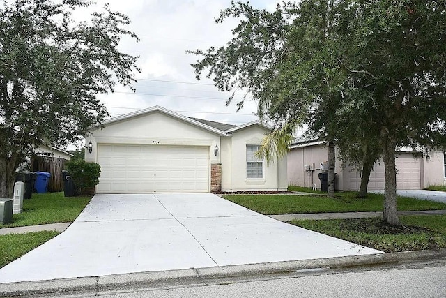 ranch-style house featuring a garage and a front lawn