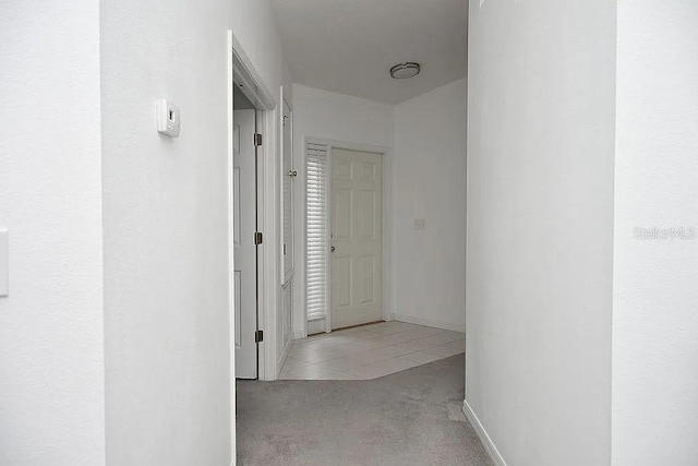 hall with light colored carpet