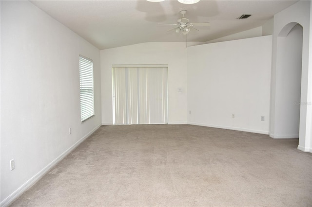 carpeted spare room featuring ceiling fan and lofted ceiling