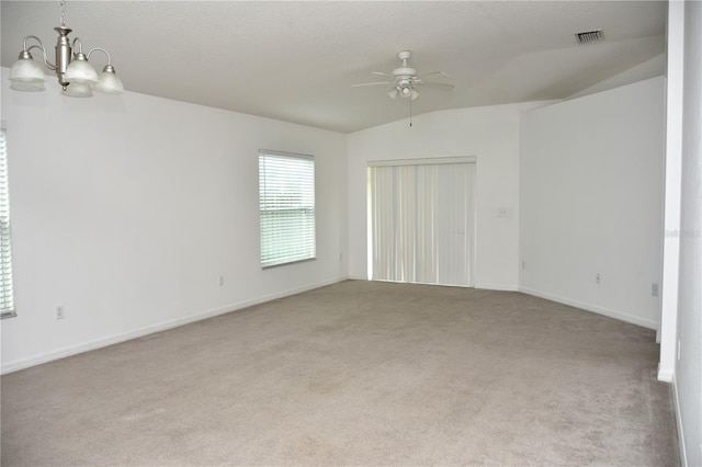 spare room with light carpet, lofted ceiling, and ceiling fan with notable chandelier