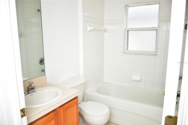 full bathroom with vanity, tiled shower / bath, and toilet