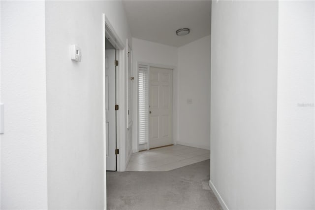 corridor featuring light colored carpet