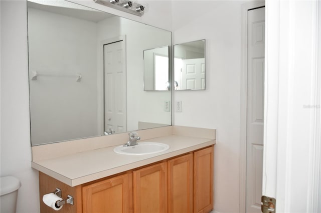 bathroom featuring vanity and toilet