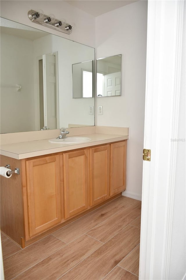 bathroom with vanity and wood-type flooring