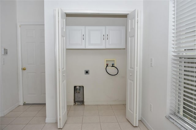 laundry room featuring cabinets, light tile patterned flooring, washer hookup, and electric dryer hookup