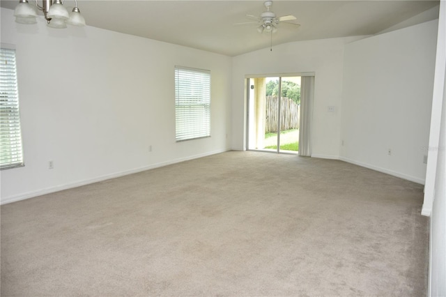 carpeted empty room with ceiling fan and vaulted ceiling