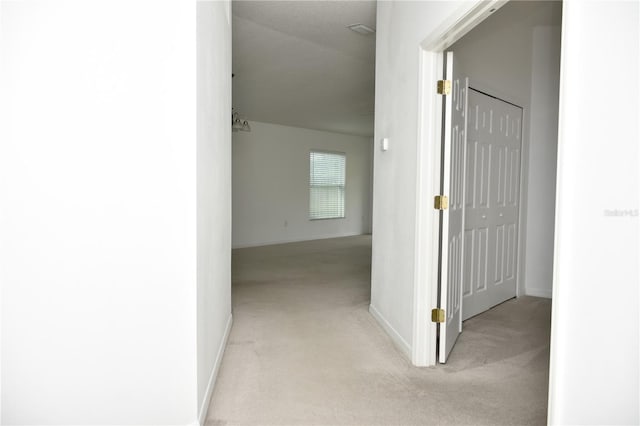 hallway featuring light carpet