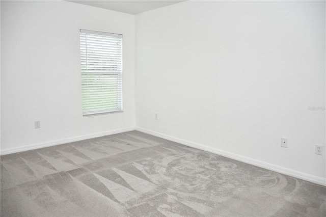 unfurnished room featuring light colored carpet