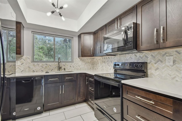 kitchen with black appliances, decorative backsplash, a raised ceiling, sink, and dark brown cabinets