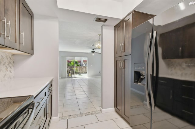 kitchen with appliances with stainless steel finishes, dark brown cabinetry, ceiling fan, and light tile patterned floors