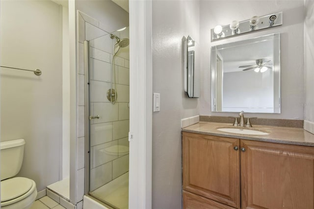 bathroom featuring ceiling fan, vanity, toilet, an enclosed shower, and tile patterned flooring