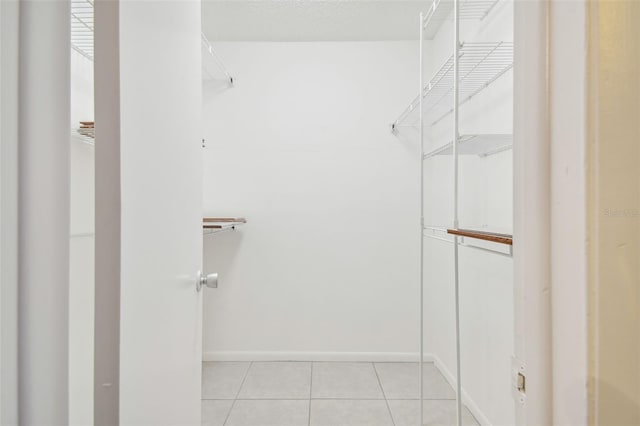 spacious closet featuring light tile patterned flooring