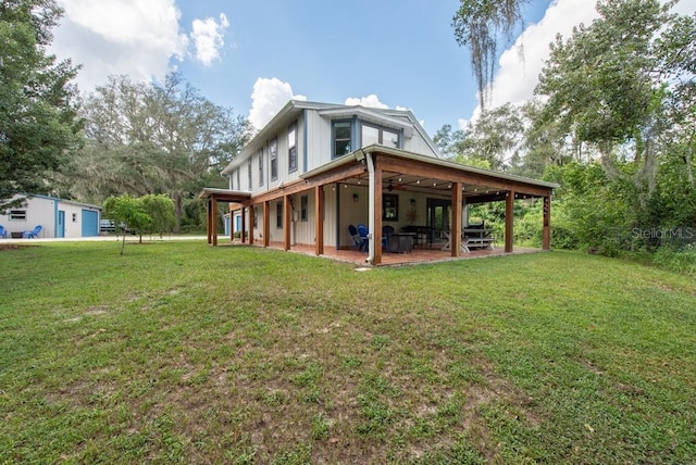 rear view of property with a lawn and a patio area