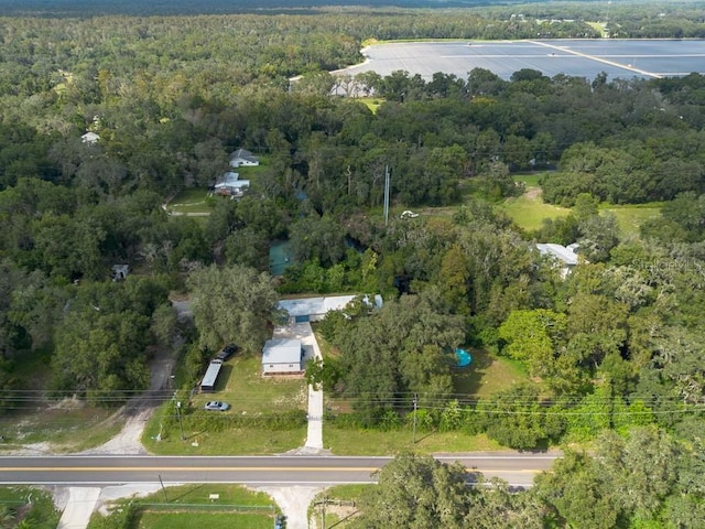 bird's eye view with a wooded view