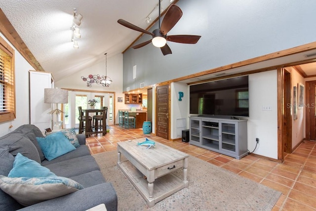 living room with rail lighting, ceiling fan with notable chandelier, a textured ceiling, high vaulted ceiling, and light tile patterned flooring