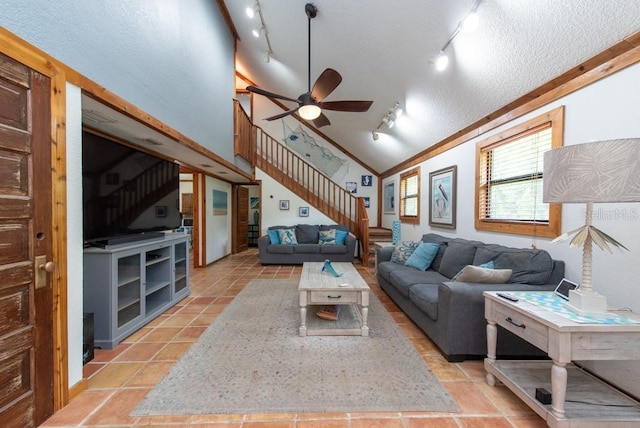 living room featuring rail lighting, ornamental molding, a textured ceiling, ceiling fan, and lofted ceiling