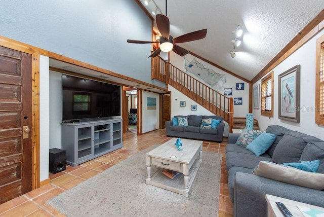 tiled living room featuring a textured ceiling, crown molding, ceiling fan, and lofted ceiling