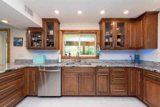 kitchen with dishwasher, sink, light tile patterned floors, and light stone countertops