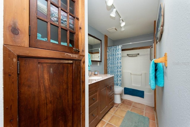 full bathroom featuring tile patterned floors, vanity, toilet, and shower / bathtub combination with curtain