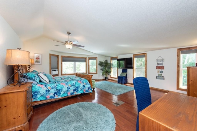 bedroom with multiple windows, vaulted ceiling, ceiling fan, and dark wood-type flooring