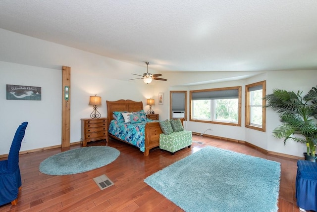 bedroom featuring ceiling fan, dark hardwood / wood-style floors, and vaulted ceiling