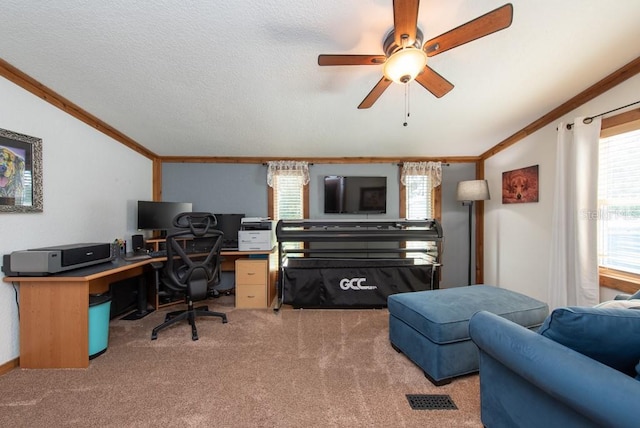 carpeted office with ceiling fan, ornamental molding, and lofted ceiling