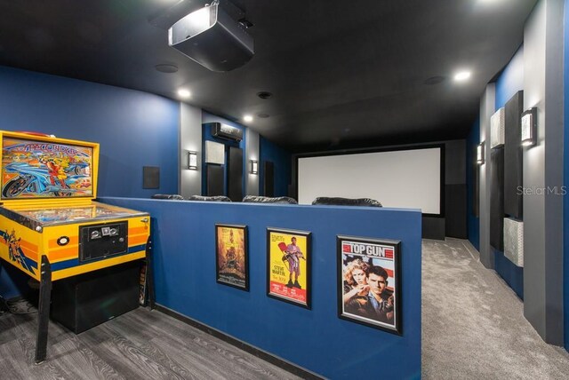 cinema room with dark hardwood / wood-style flooring