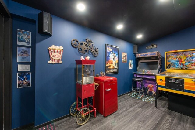 game room featuring dark hardwood / wood-style floors and lofted ceiling