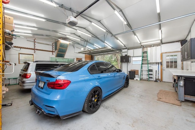 garage featuring electric panel and a garage door opener