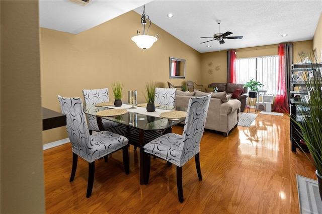 dining space with lofted ceiling, ceiling fan, and hardwood / wood-style floors