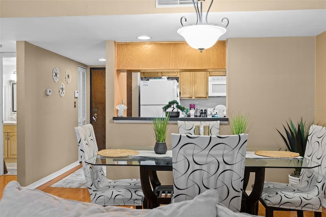 dining space with light wood-type flooring