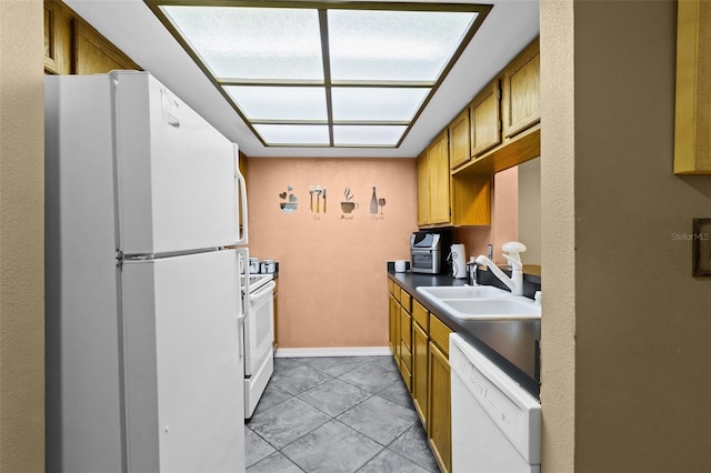 kitchen with white appliances, light tile patterned flooring, and sink