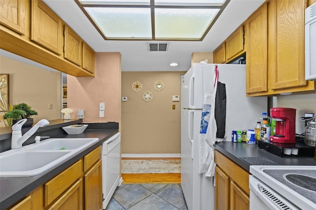 kitchen featuring white appliances, light tile patterned flooring, and sink