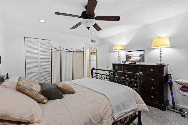 carpeted bedroom featuring ceiling fan, a textured ceiling, and white fridge