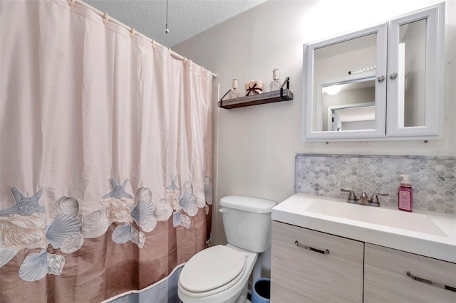 bathroom featuring vanity, decorative backsplash, a textured ceiling, and toilet