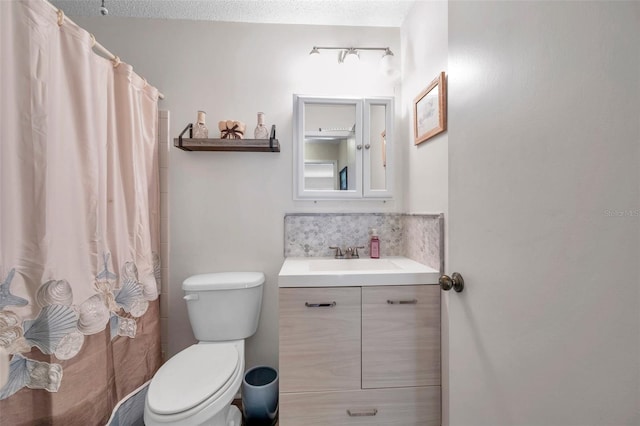 bathroom featuring vanity, toilet, a textured ceiling, and walk in shower