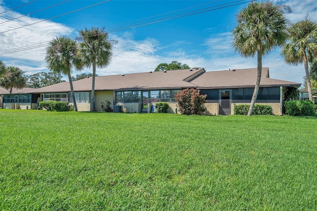 rear view of house featuring a yard and cooling unit