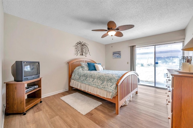 bedroom with light hardwood / wood-style floors, access to outside, a textured ceiling, and ceiling fan