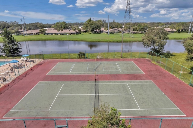 view of tennis court with basketball court and a water view