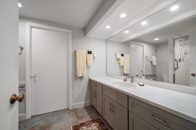 bathroom featuring a shower with door, vanity, and toilet