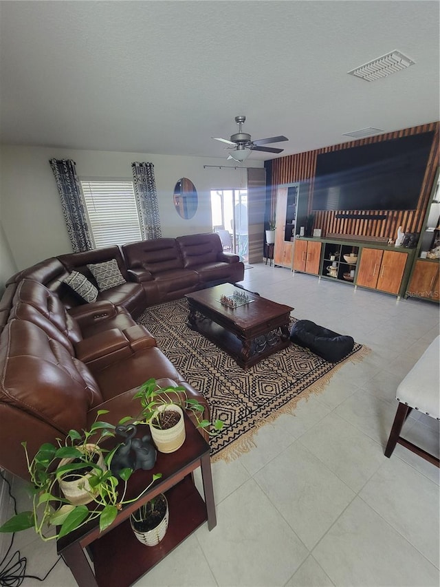 tiled living room with ceiling fan