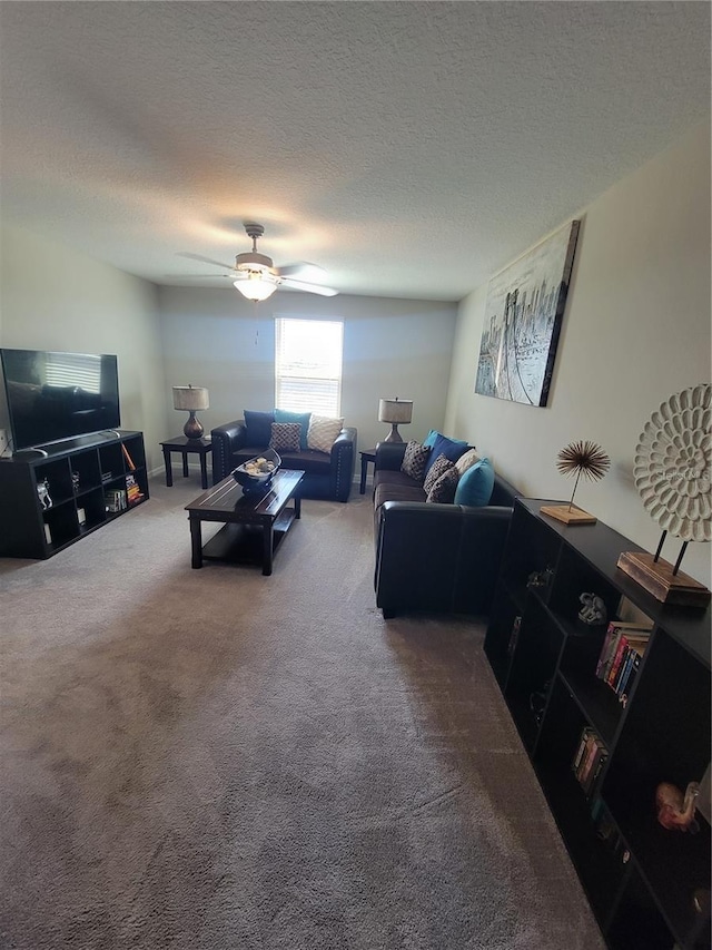 living room featuring a textured ceiling, carpet flooring, and ceiling fan