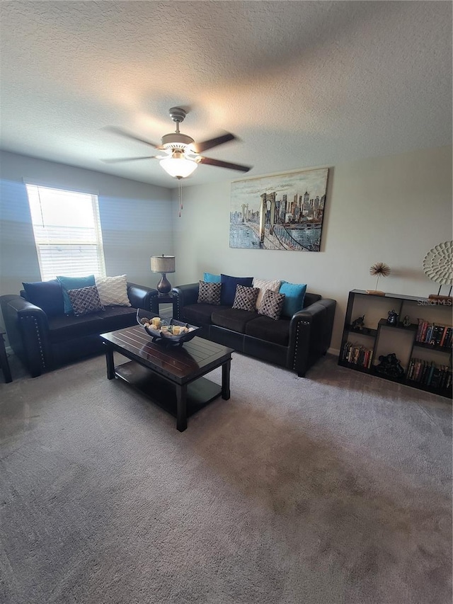 living room with a textured ceiling, carpet flooring, and ceiling fan