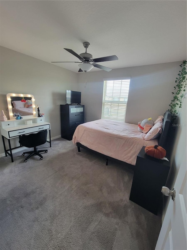 bedroom with ceiling fan and carpet flooring